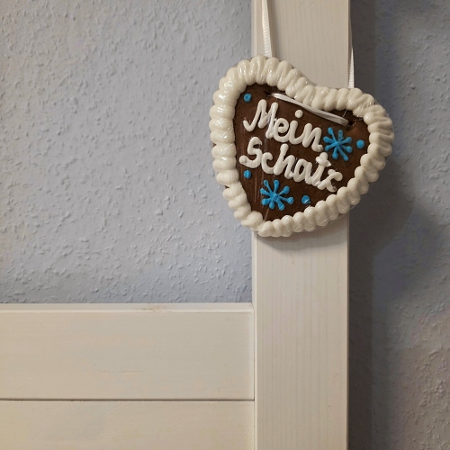 Kleines Lebkuchenherz mit der Aufschrift Mein Schatz h&auml;ngt am Bettrahmen